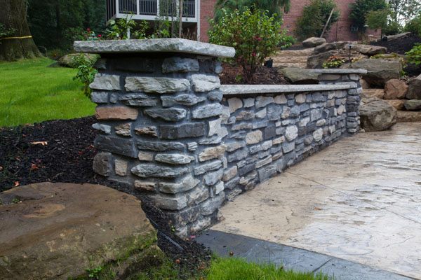 Decorative Stone Wall Along Concrete Patio